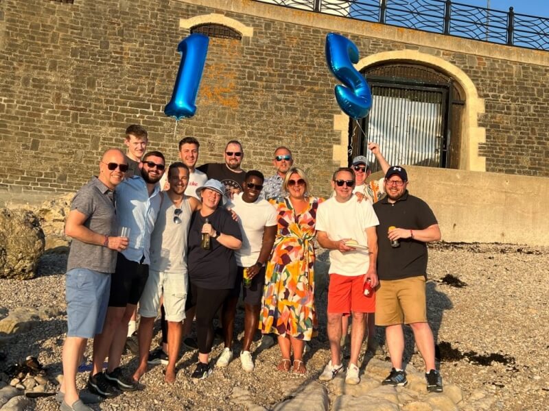 The Aquarian Cladding team celebrating on the beach